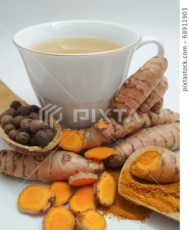 Turmeric milk in a cup and ingredients to prepare it, Ayurvedic drink, turmeric 68911903