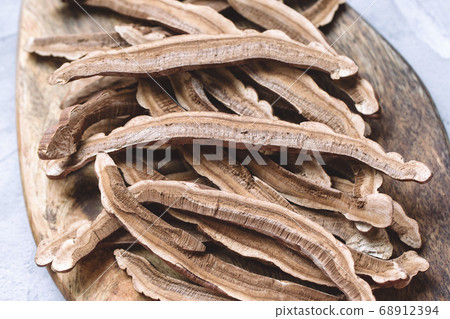 Lingzhi or reishi mushroom on a wooden board Lingzhi or reishi mushroom on a wooden board 68912394