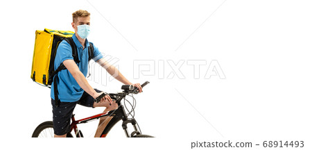 Deliveryman isolated on white studio background. Contacless delivery service during quarantine. Deliveryman isolated on white studio background. Contacless delivery service during quarantine. 68914493