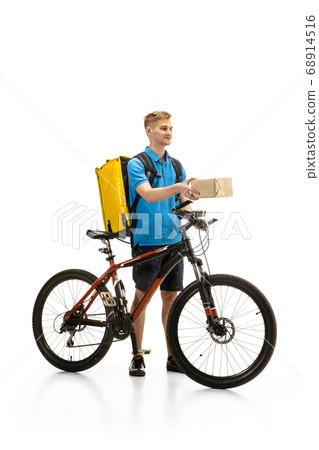 Deliveryman isolated on white studio background. Contacless delivery service during quarantine. Deliveryman isolated on white studio background. Contacless delivery service during quarantine. 68914516