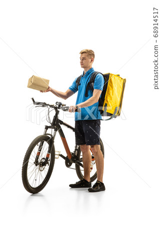 Deliveryman isolated on white studio background. Contacless delivery service during quarantine. Deliveryman isolated on white studio background. Contacless delivery service during quarantine. 68914517