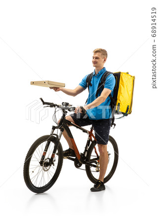Deliveryman isolated on white studio background. Contacless delivery service during quarantine. Deliveryman isolated on white studio background. Contacless delivery service during quarantine. 68914519