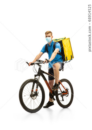Deliveryman isolated on white studio background. Contacless delivery service during quarantine. Deliveryman isolated on white studio background. Contacless delivery service during quarantine. 68914525