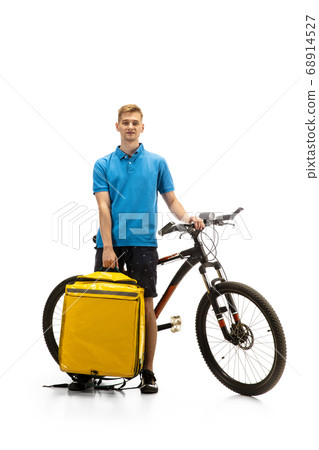 Deliveryman isolated on white studio background. Contacless delivery service during quarantine. Deliveryman isolated on white studio background. Contacless delivery service during quarantine. 68914527
