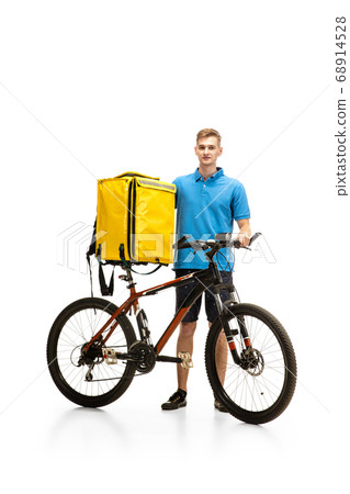 Deliveryman isolated on white studio background. Contacless delivery service during quarantine. 68914528