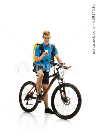 Deliveryman isolated on white studio background. Contacless delivery service during quarantine. 68914530