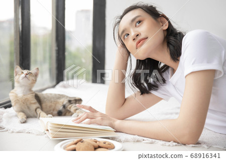 Female lifestyle cat relaxing Female lifestyle cat relaxing 68916341