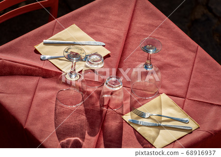 Outdoor restaurant table with cutlery and glasses - Liguria Italy 68916937