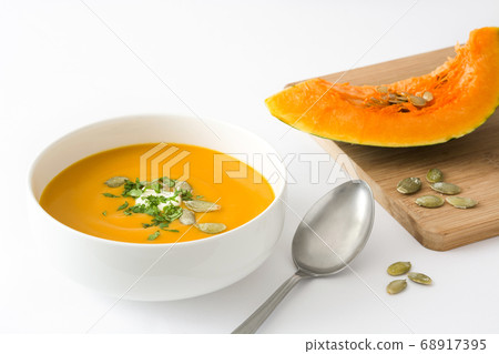 Pumpkin soup in bowl isolated on white background Pumpkin soup in bowl isolated on white background 68917395