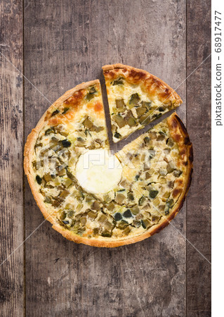 French quiche with vegetables on a rustic wooden table	 68917477