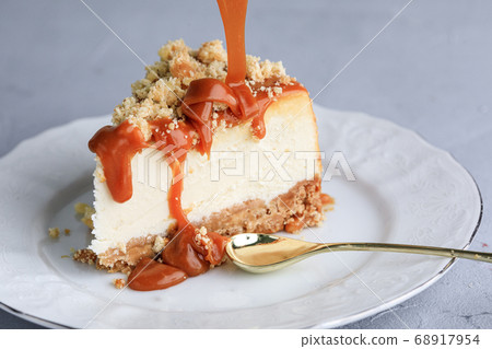 Slice Of Classical New York Cheesecake On White Plate. Closeup View. Cheesecake with caramel  68917954