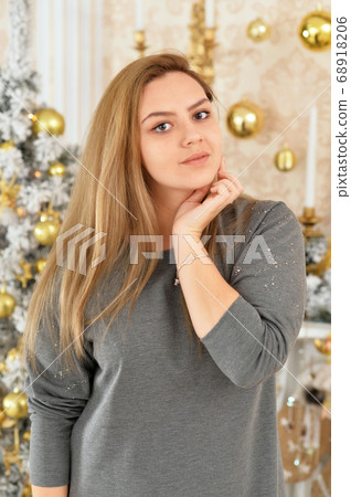 Portrait of beautiful young woman posing in room Portrait of beautiful young woman posing in room 68918206