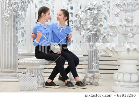 Cute little girls with gift in studio Cute little girls with gift in studio 68918280