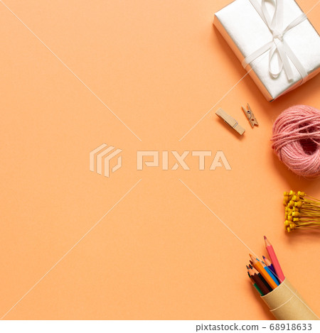 Gift box, string roll, colored pencil on orange background. flat lay, top view, copy space Gift box, string roll, colored pencil on orange background. flat lay, top view, copy space 68918633