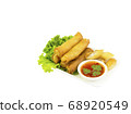 Fried spring rolls with lettuce and dipping sauce on a white plate. Selective focus. 68920549