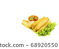 Fried spring rolls with lettuce and dipping sauce on a white plate. Selective focus. 68920550