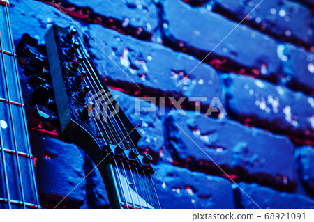 Guitar headstock with tuners on dark background Guitar headstock with tuners on dark background 68921091