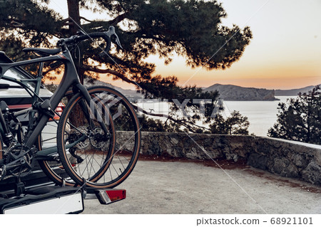 Crossover car with two road bicycles loaded on a rack Crossover car with two road bicycles loaded on a rack 68921101