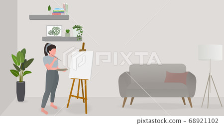 Woman using weekend holiday with drawing at living room.  68921102