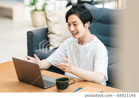 Man doing remote work at home Man doing remote work at home 68921148