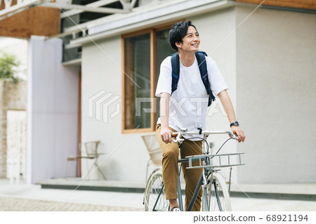 A man going out on a bicycle A man going out on a bicycle 68921194