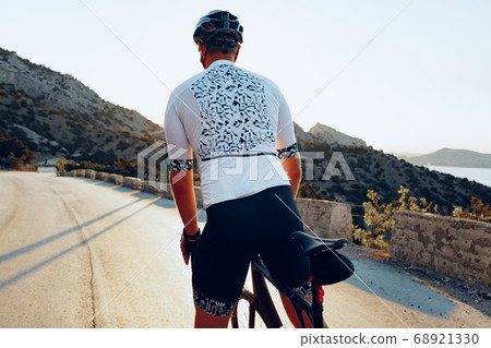 Cycling sport athlete man riding on coastal road 68921330