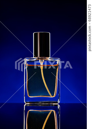 Glass bottle with cosmetic oil on dark background Glass bottle with cosmetic oil on dark background 68921473