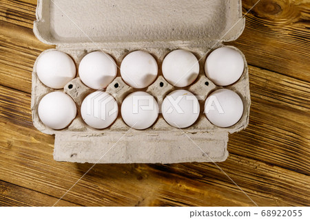 Raw chicken eggs in cardboard egg box Raw chicken eggs in cardboard egg box 68922055