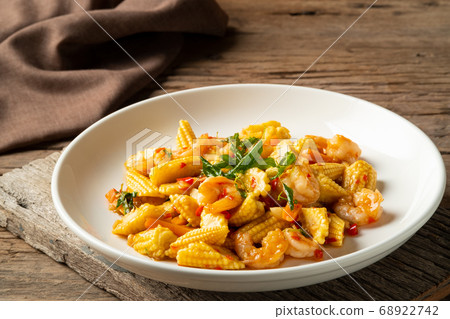 Stir fried young corn with shrimps and basil. Stir fried young corn with shrimps and basil. 68922742