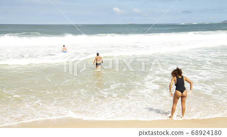 Rio de Janeiro, Brasil- February 28, 2020: Citizens swim and sunbathe on the beach of Copacabana Rio de Janeiro, Brasil- February 28, 2020: Citizens swim and sunbathe on the beach of Copacabana 68924180