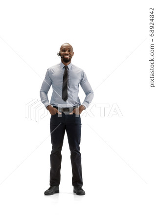 Young african-american call center consultant with headset isolated on white studio background Young african-american call center consultant with headset isolated on white studio background 68924842