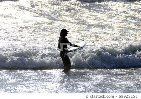 A surfer heading off the coast A surfer heading off the coast 68925153