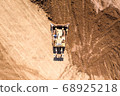 Bulldozer pushing large amount of fresh soil, Aerial shot. 68925218