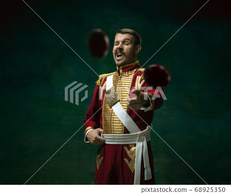 Young man as Nicholas II on dark green background. Retro style, comparison of eras concept. Young man as Nicholas II on dark green background. Retro style, comparison of eras concept. 68925350