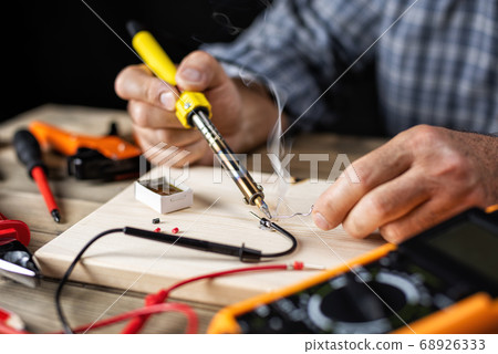 Electrician technician at work. Electronics. 68926333