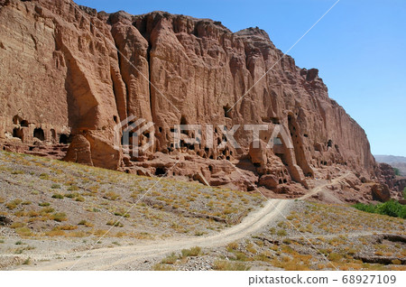 Caves in the cliffs near Bamyan (Bamiyan), Afghanistan. Local Afghan people still live in the caves. The caves are in cliffs where the Bamyan (Bamiyan) Buddhas used to stand. UNESCO site Afghanistan. Caves in the cliffs near Bamyan (Bamiyan), Afghanistan. Local Afghan people still live in the caves. The caves are in cliffs where the Bamyan (Bamiyan) Buddhas used to stand. UNESCO site Afghanistan. 68927109