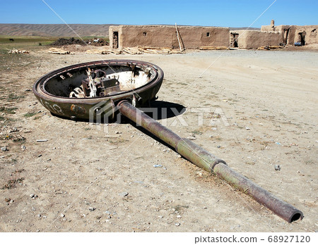 Bamyan (Bamiyan), Central Afghanistan. A turret from a destroyed tank - a reminder of the Afghanistan war. There are many abandoned tanks and weapons from the Afghan war near Bamyan (Bamiyan). Bamyan (Bamiyan), Central Afghanistan. A turret from a destroyed tank - a reminder of the Afghanistan war. There are many abandoned tanks and weapons from the Afghan war near Bamyan (Bamiyan). 68927120