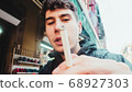 Boy with a cigar in his hand posing for the camera 68927303