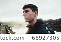 Boy staring at backlight with serious look 68927305