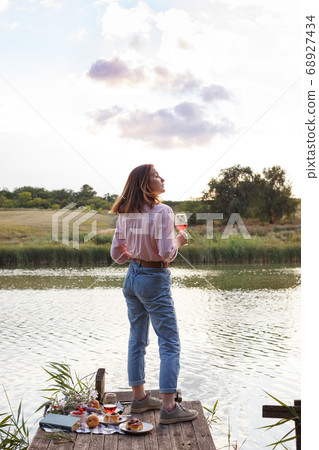 girl enjoying picnic on a wooden pie 68927434