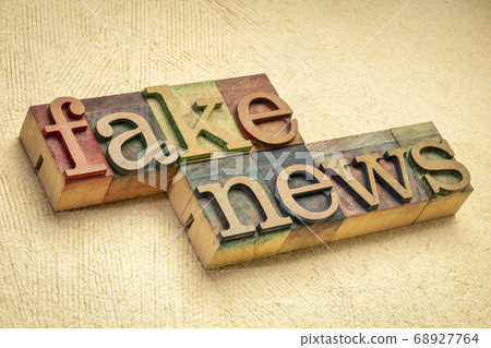 fake news word abstract in wood type 68927764