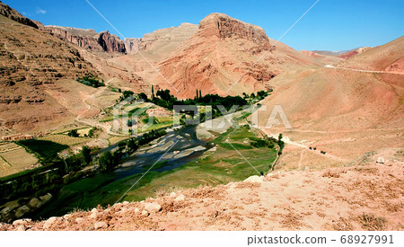 Mountain scenery of Afghanistan near Yakawlang in Bamyan (Bamiyan) Province. These colorful mountains are at the western end of the Hindu Kush mountain range in Central Afghanistan. River and trees. Mountain scenery of Afghanistan near Yakawlang in Bamyan (Bamiyan) Province. These colorful mountains are at the western end of the Hindu Kush mountain range in Central Afghanistan. River and trees. 68927991