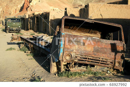 A rusting old truck is abandoned by the roadside in Yakawlang in Central Afghanistan. It was possibly a Kamaz truck which are widespread in Afghanistan. Any branding has long since been lost. 68927992