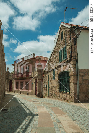 Old house with stone wall on deserted alley Old house with stone wall on deserted alley 68928029