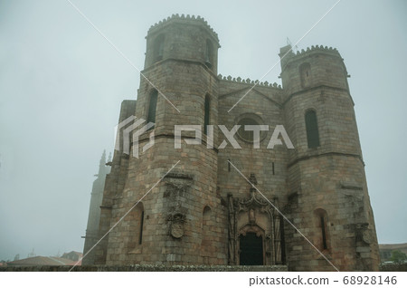Gothic Cathedral with steeples in the morning mist 68928146