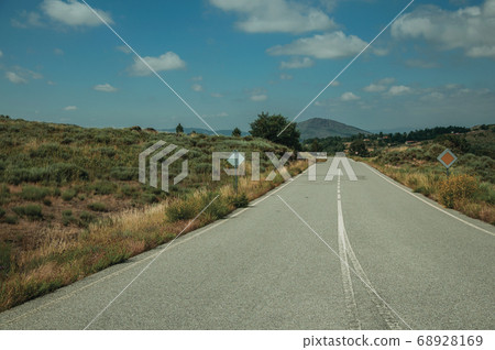 Deserted straight road on rural landscape Deserted straight road on rural landscape 68928169