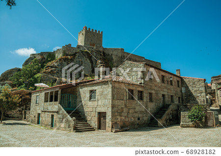 Gothic house and castle with tower on top of rocky hill Gothic house and castle with tower on top of rocky hill 68928182