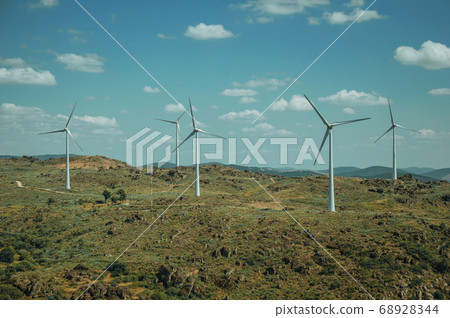 Several wind turbines over hilly landscape Several wind turbines over hilly landscape 68928344