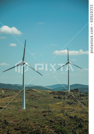 Wind turbines over hilly landscape Wind turbines over hilly landscape 68928355