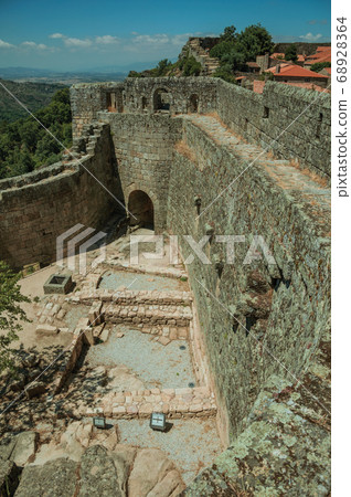 Pathway on stone wall with the front gate of Castle 68928364